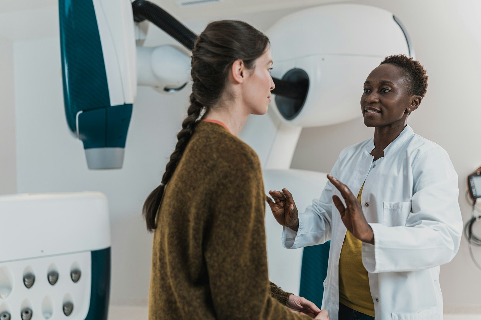 Clinician speaking with a patient in a healthcare treatment room