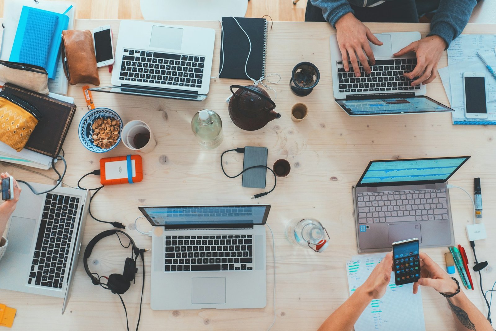 Technology team working across laptops and mobile devices